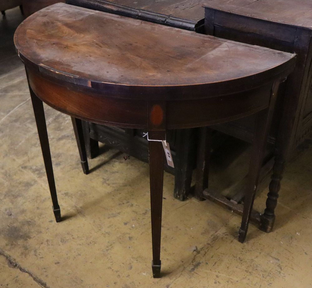 A George III mahogany D shape folding tea table, width 91cm depth 45cm height 75cm